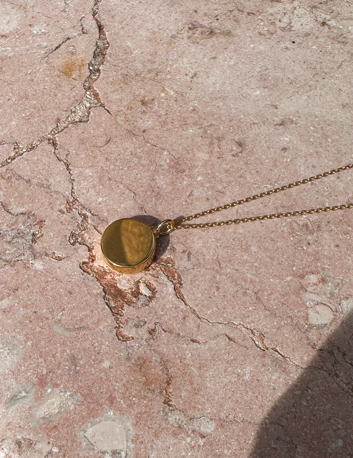 Circle urn necklace in gold vermeil for holding ashes, top view